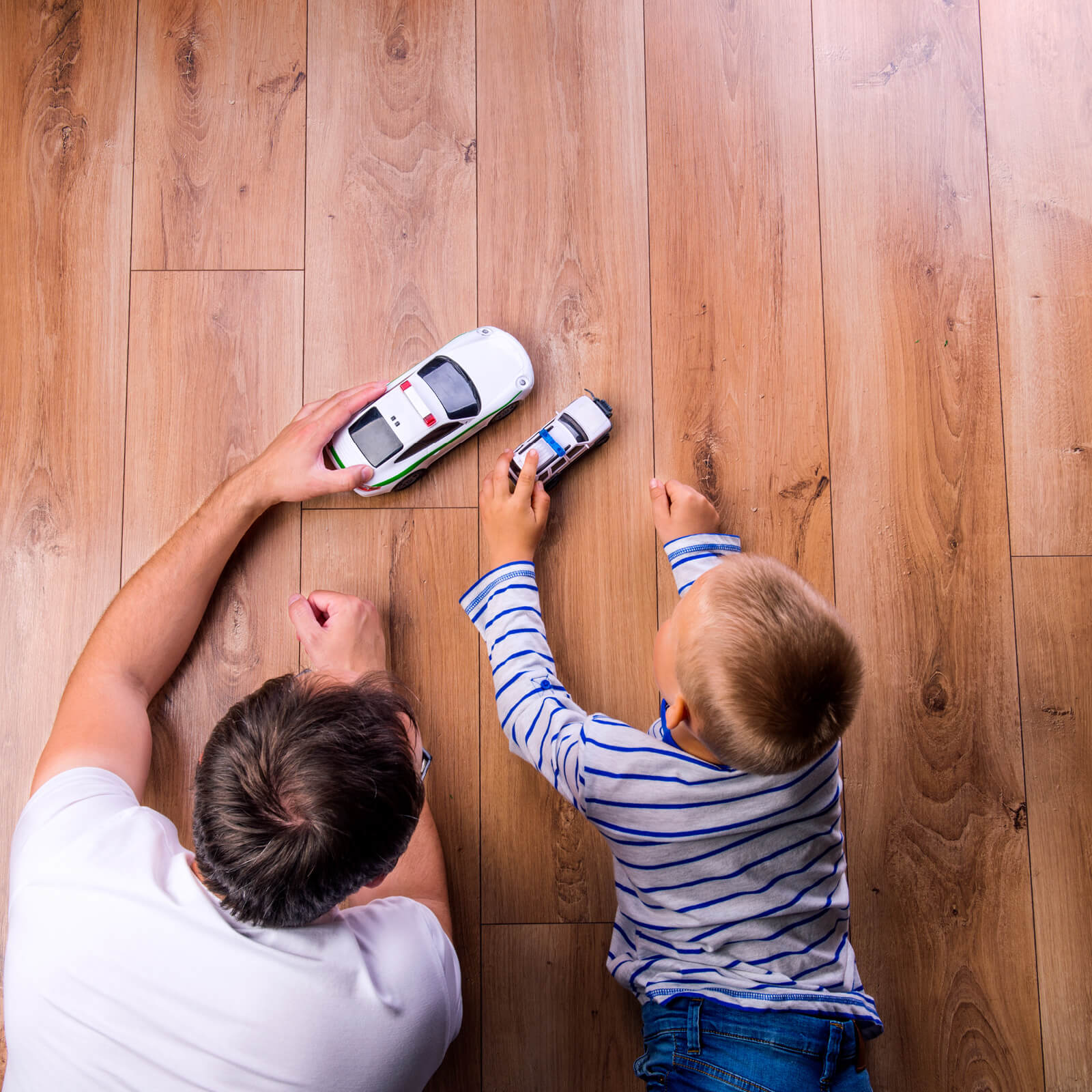 Dad child playing on Hardwood | Kopp's Carpet & Decorating